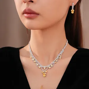 Elegante zirkonia sieradenset met gele druppelhanger ketting en bijpassende oorbellen