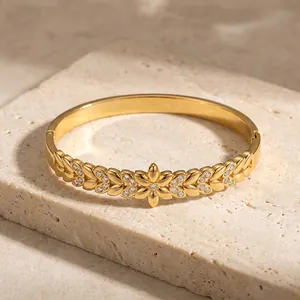 Detailed view of floral engraved stainless steel bangle with sparkling rhinestones
