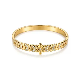 Detailed view of 18K gold-plated stainless steel bangle with rhinestone floral design
