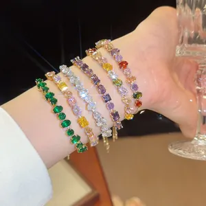 Close-up of multi-color 18k gold plated zircon bracelets on wrist showing brilliant sparkle