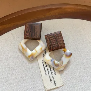 Vintage square earrings featuring dark wood grain and marbled resin design details