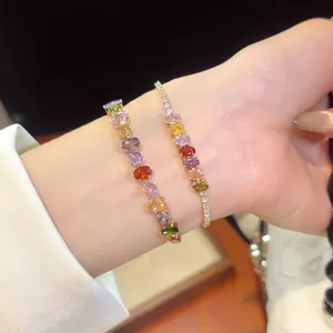 Detailed view of 18k gold-plated bracelets featuring vibrant multi-color zircons