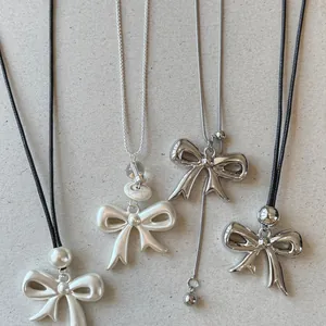 Detailed view of trendy Korean style bow necklaces with leather cords and silver chains