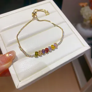 Macro detail of 18k gold plated bracelet with sparkling colorful zirconia stones