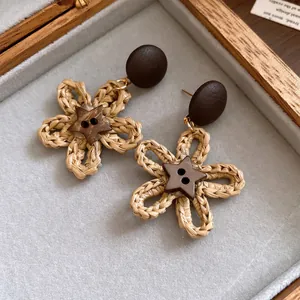 Detailed macro view of retro woven flower earrings with star-shaped wooden button studs