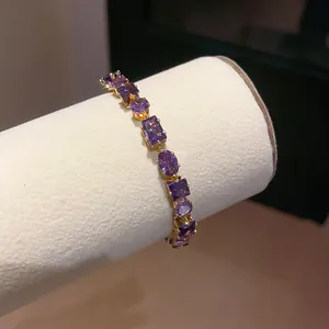 Macro view of geometric purple zircon bracelet with elegant 18k gold plated finish