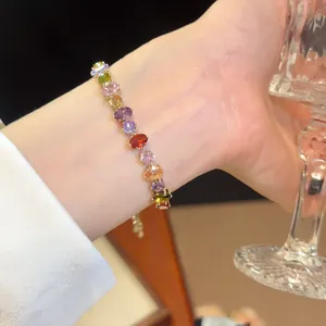 Detail shot of a sparkling 18k gold plated colorful cubic zirconia bracelet on a wrist