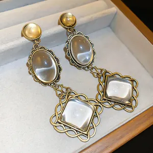 Elegant vintage gold-tone dangle earrings with oval and square clear glass cabochons