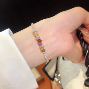 Close-up of a sparkling 18k gold plated bracelet with multi-colored oval cubic zirconia stones