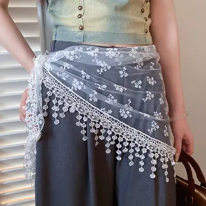Close-up of elegant white floral lace mesh waist scarf featuring decorative tassel fringe