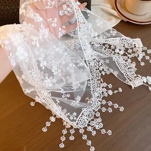 Detail view of white floral lace mesh scarf featuring elegant hanging pendants