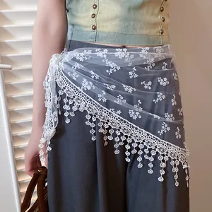 Detailed macro view of white floral lace mesh waist scarf with elegant fringe