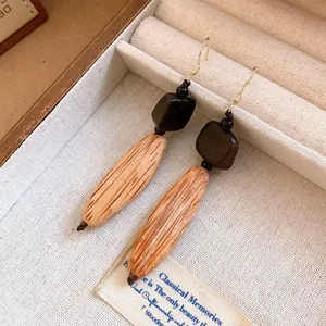 Close-up of vintage irregular wooden earrings with unique natural grain texture