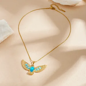 Gedetailleerd close-up van een vergulde adelaar ketting met levendige blauwe edelstenen