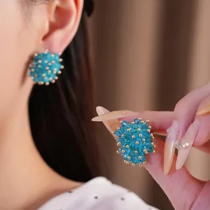 Elegant blue crystal beaded cluster earrings with gold accents and silver needle