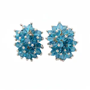 Elegant blue faceted glass cluster stud earrings with silver pins for a vacation look.