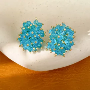 Detail view showing the intricate blue crystal beads of these glass stud earrings.