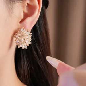 Detailed close-up showing an elegant clear glass bead cluster stud earring on ear