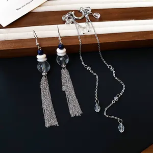 Vue macro détaillée des boucles d'oreilles à glands en cristal et des manchettes d'oreilles.
