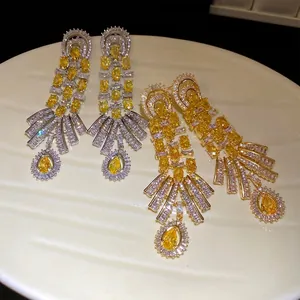 Vintage palace style earrings with 18k gold plating and yellow cubic zirconia drops.