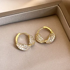 Detailed view of 14k gold-plated twisted hoop earrings with pavé cubic zirconia