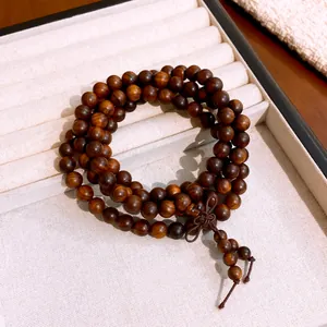 Macro view of polished wooden beads showing natural grain and decorative knot detail