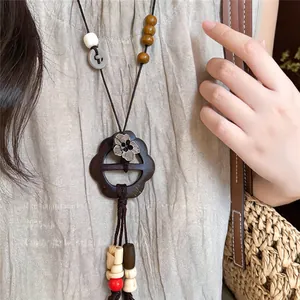 Detailed close-up of a New Chinese style wooden plum blossom necklace with artistic beads.