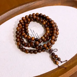 Detailed view of handcrafted multilayered wooden bead bracelet with a decorative knot.