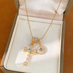 Close-up of 18k gold plated necklace with zircon-studded star and cross pendants.