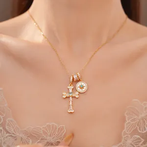 Close-up detail of 18k gold plated necklace with zircon star and cross pendants