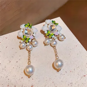Elegant vintage floral drop earrings featuring white resin flowers pearls and crystal butterflies