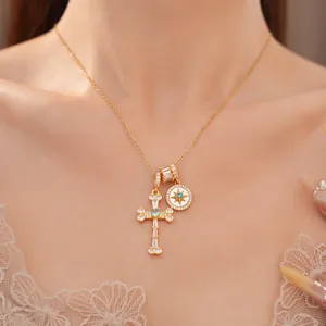 Close-up of a gold-plated necklace featuring sparkling zircon star and cross charms.