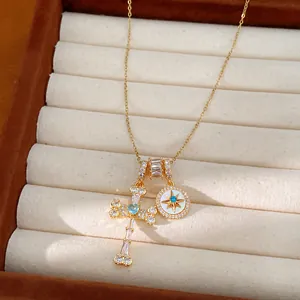 Macro view of a 18k gold plated necklace featuring star and cross pendants with zircons
