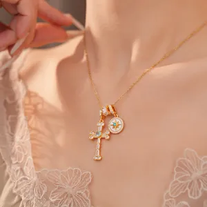 Close-up of 18k gold-plated necklace with cubic zirconia cross and North Star pendant.