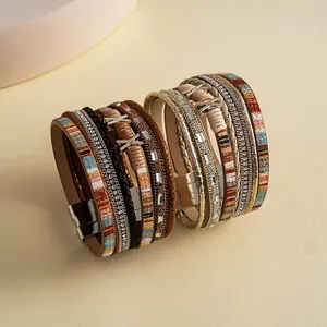 Close-up detail of bohemian multi-layer leather braided bracelets with sparkling rhinestones