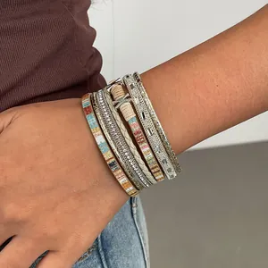 Boho multi-layer leather bracelet with crystals and ethnic braided ropes on wrist.