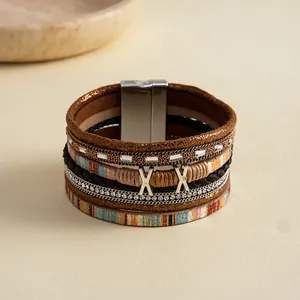 Macro detail of Bohemian multi-layer leather bracelet with rhinestones and magnetic clasp