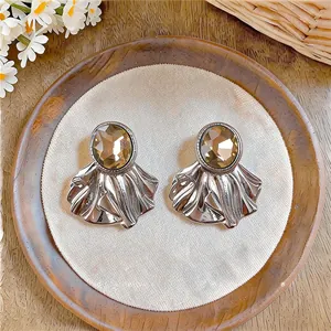 Detailed view of silver oval gemstone earrings with unique pleated fan metal design