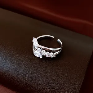 Elegant 18k gold plated open ring with sparkling zircon stones in a double-band design.