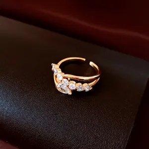 Detailed close-up of 18k gold plated open ring with shimmering white zircon stones