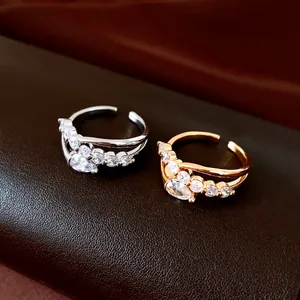 Close-up of elegant gold and silver plated open rings with sparkling cubic zirconia stones