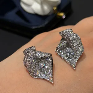 Détail rapproché d'élégantes boucles d'oreilles tulipe argentées avec zircons pavés