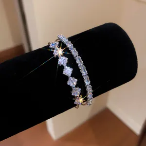 Close-up of luxury double-layer open bangle with sparkling cubic zirconia stones