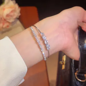 Close-up of 18k gold plated double layer bracelet with sparkling zircon stones on wrist.