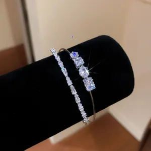 Close-up of sparkling zircon double-layer 18k silver plated open bangle on black velvet.
