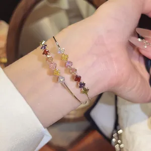 Detail shot of 18k gold plated double-layer bangle with colorful square zircons.