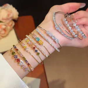 Detailed view of 18k gold plated open bangles with sparkling multi-color cubic zirconia