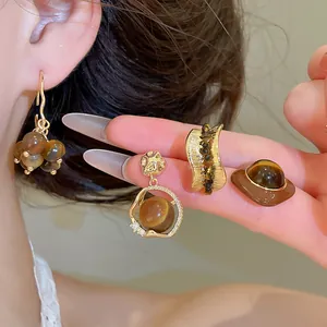 Detailed view of 18K gold plated Tiger's Eye resin earrings with vintage Maillard style.