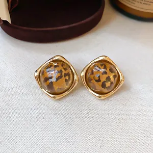Vintage 18K gold plated stud earrings with leopard print resin detail.