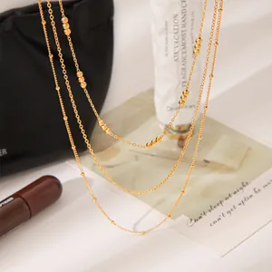 Macro detail of French vintage multi-layered gold necklace with minimalist bead accents